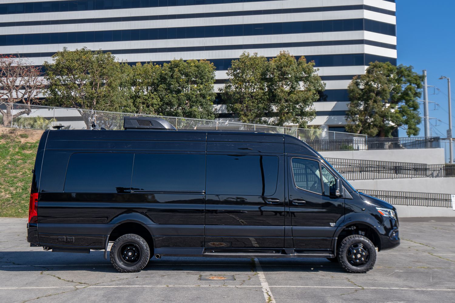 Black van parked in urban environment.