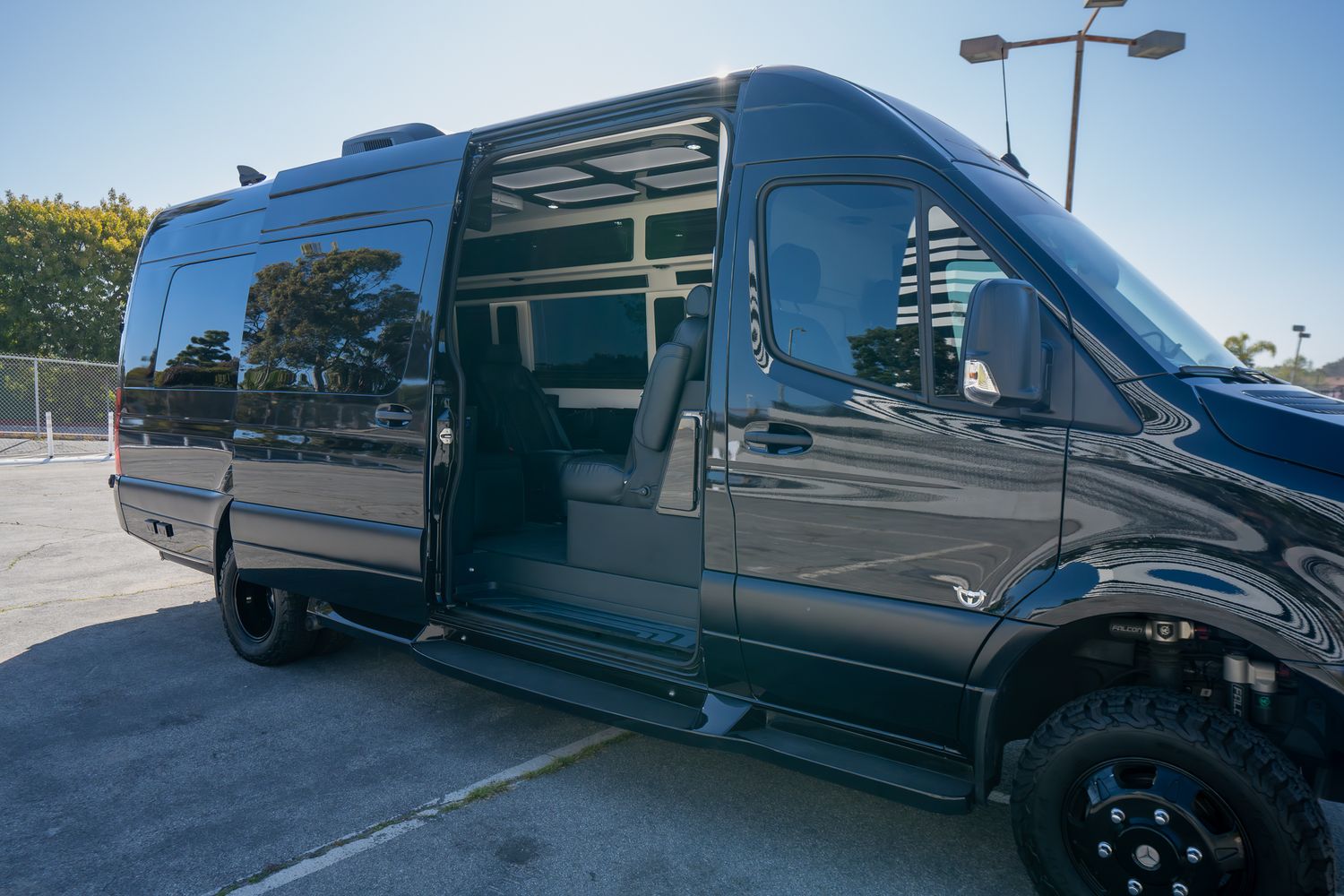 Black van parked near modern building.