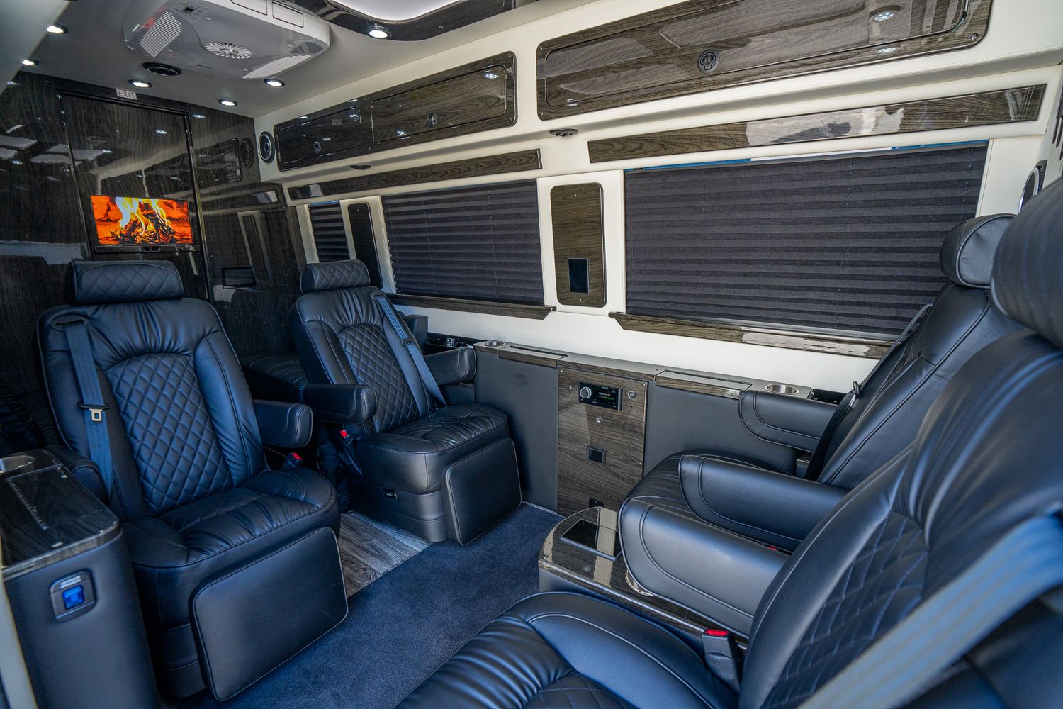 Black Mercedes van parked in sunny area.