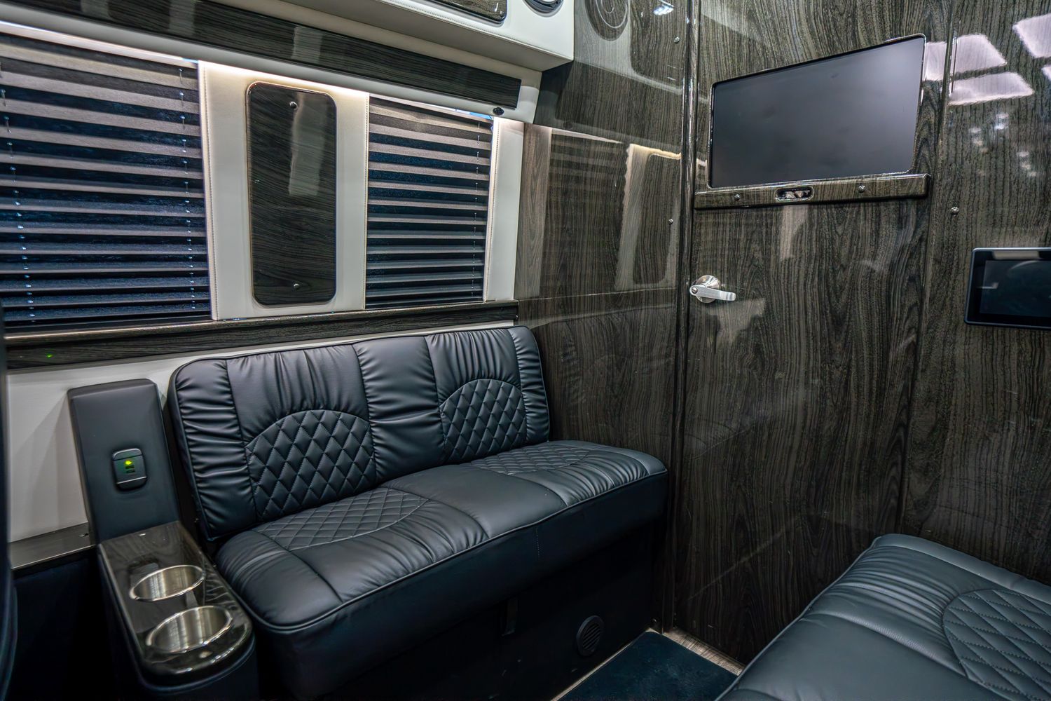 Black Mercedes van parked in an outdoor lot.