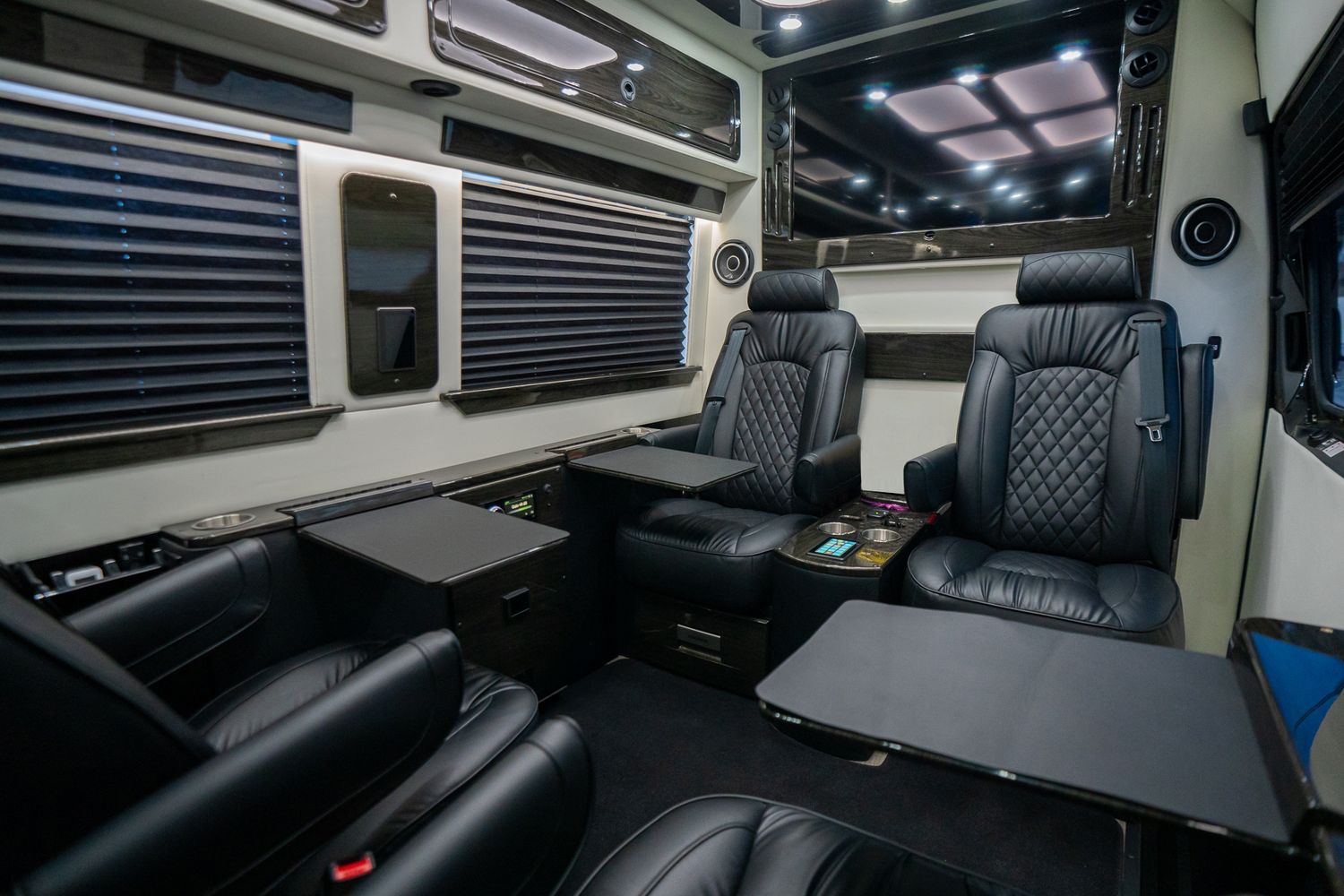Luxury van interior with leather seating and amenities.
