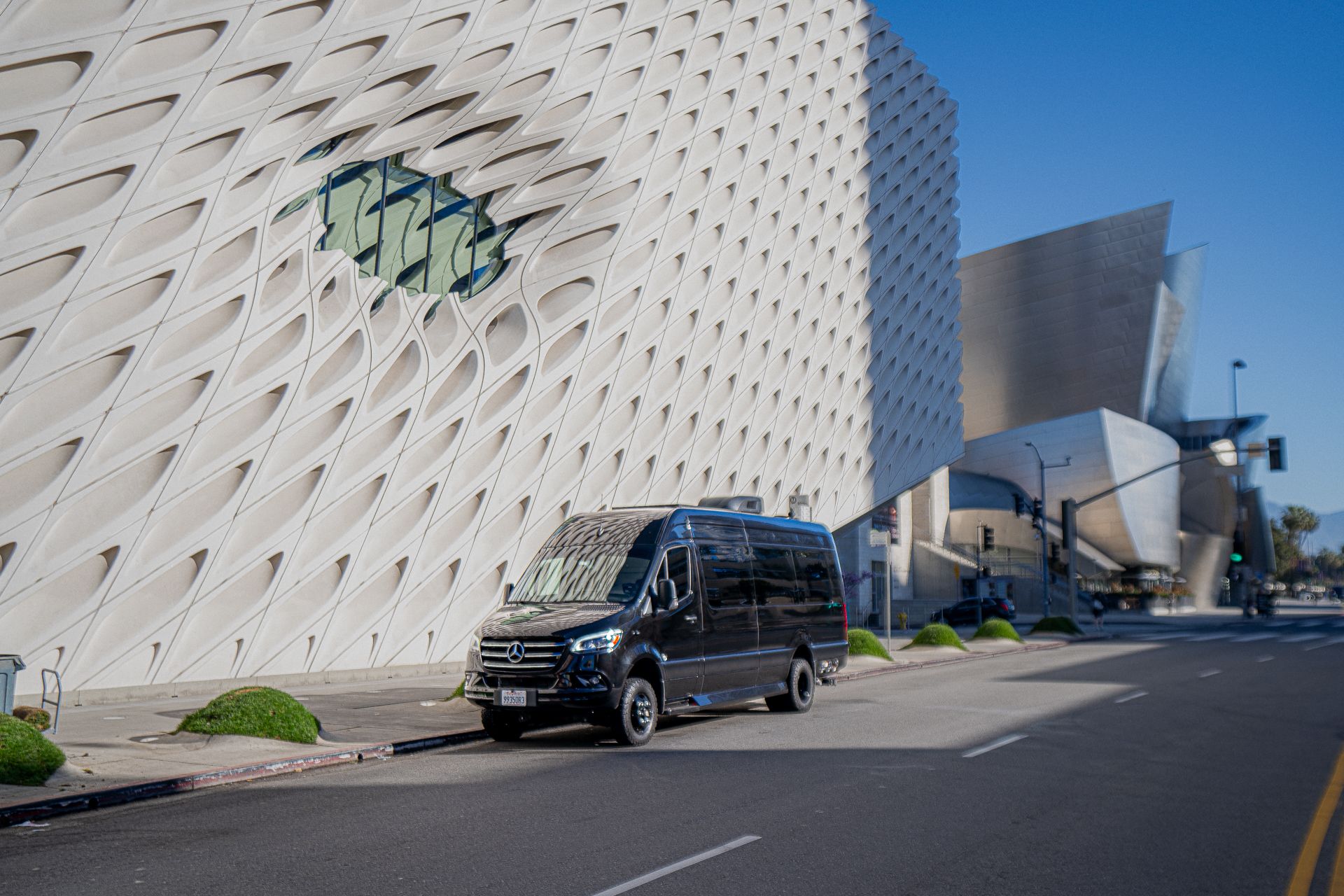 Black van near modern architectural buildings.